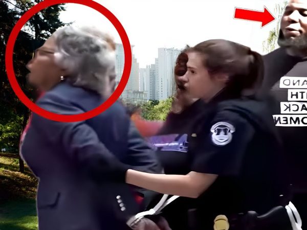 officer-harasses-black-elderly-woman-for-sitting-in-a-park,-unaware-who’s-watching-from-behind-him…